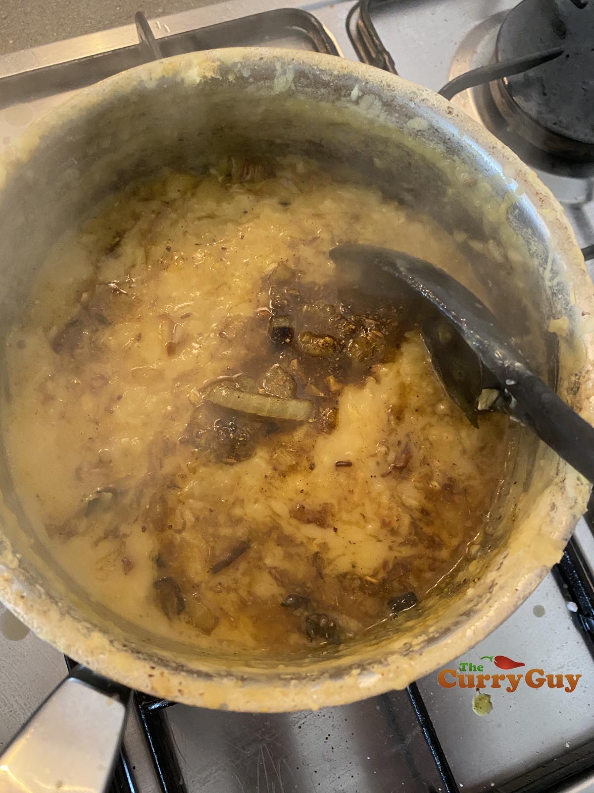 pouring tarka over the dhal