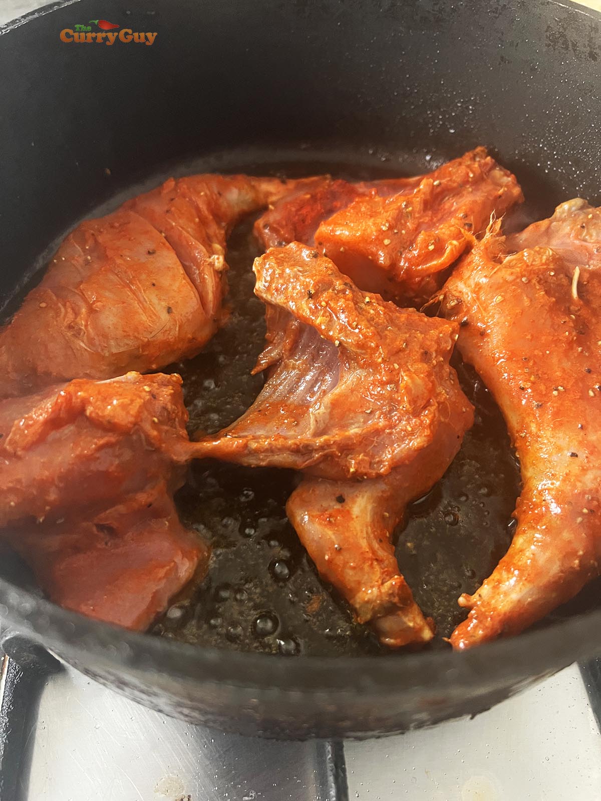 Frying the rabbit pieces.