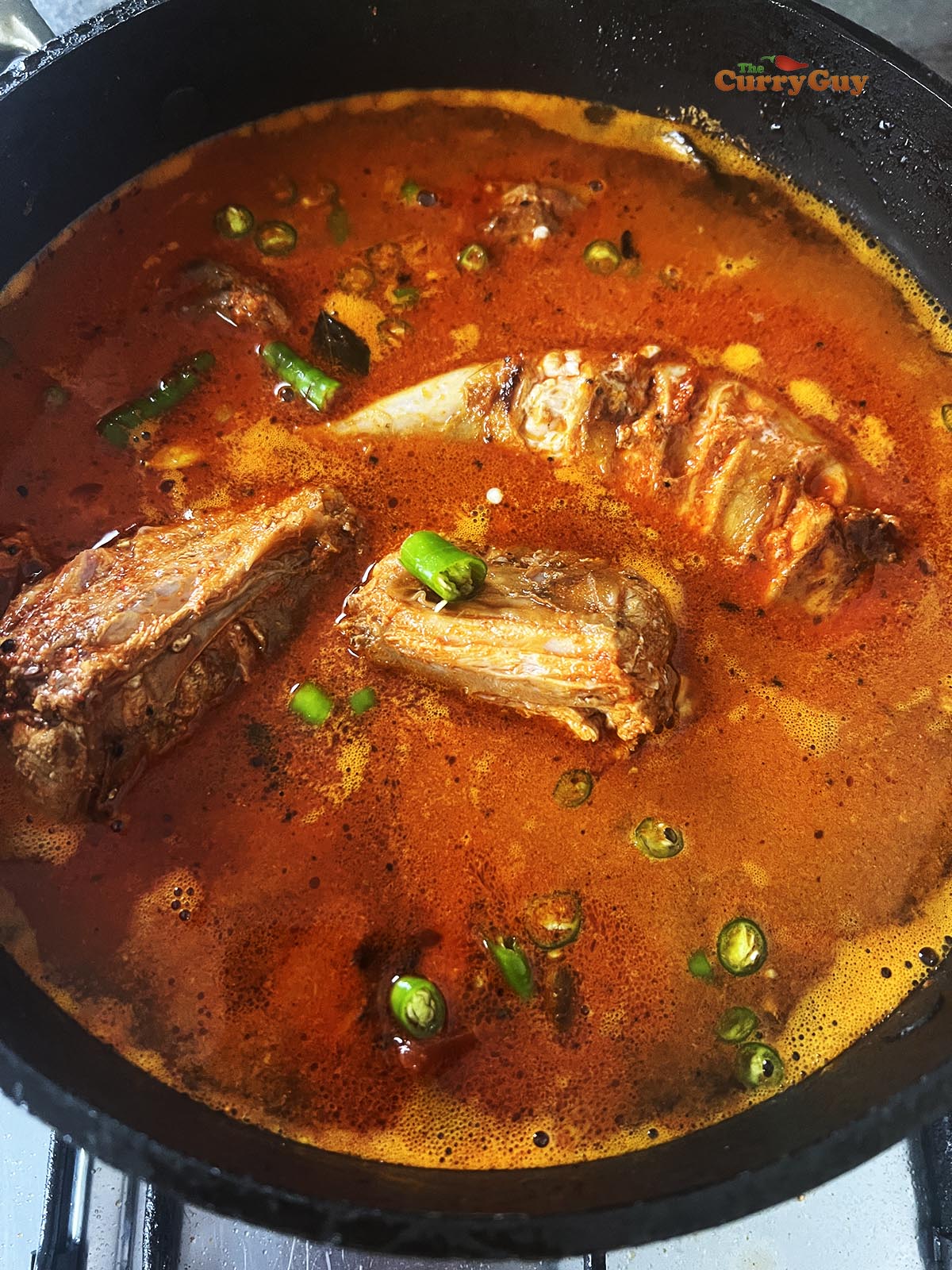 Pouring in water or stock to cover the rabbit and simmer it.