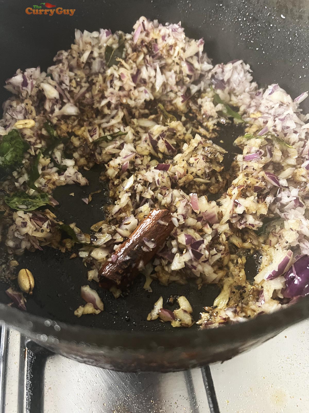 Stirring in the chopped onions to fry until soft and translucent.