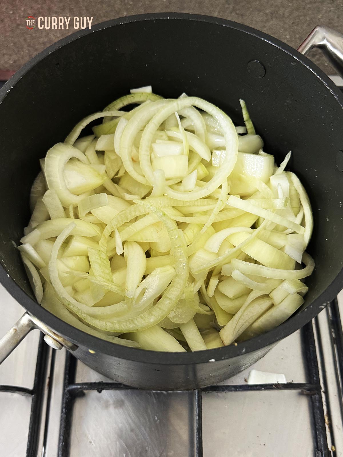 Frying the onions in oil in a pot.