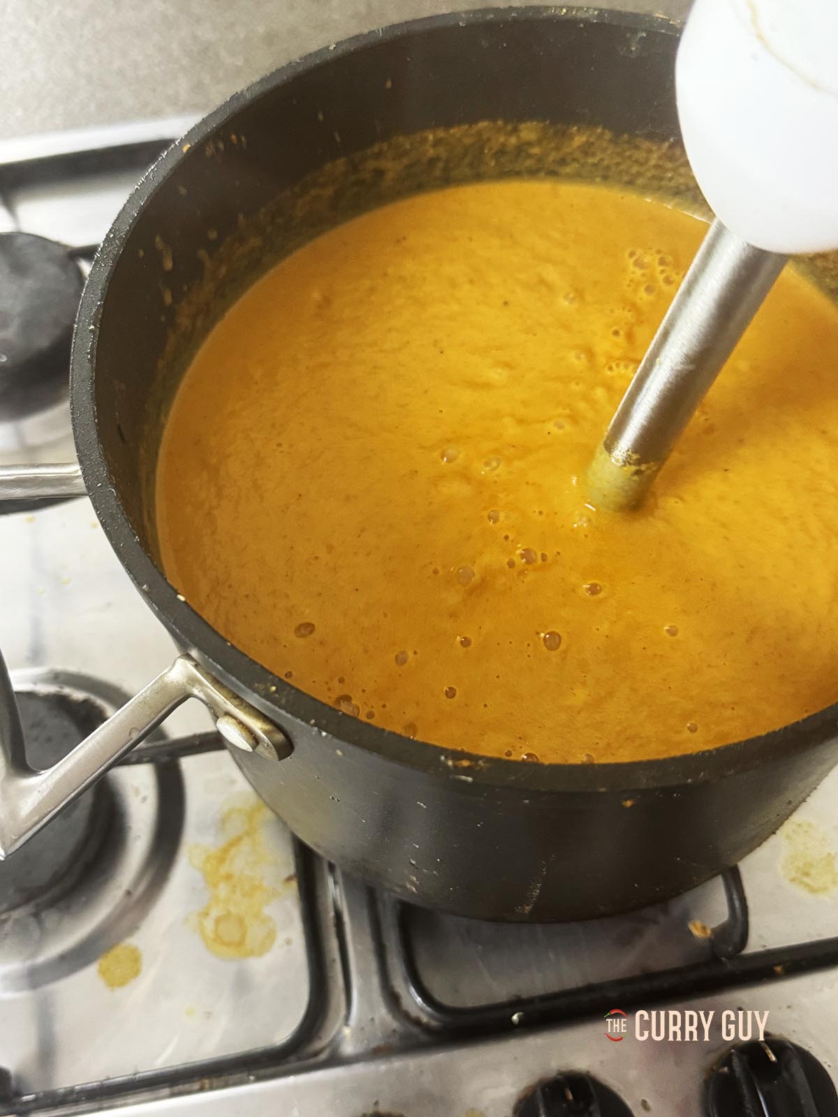 Blending the base sauce until smooth.