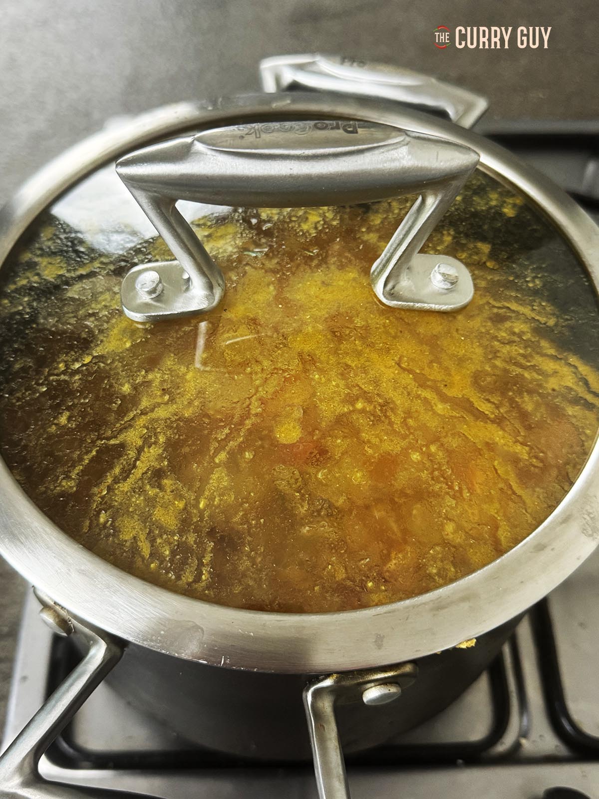 Simmering the sauce covered in the pot.