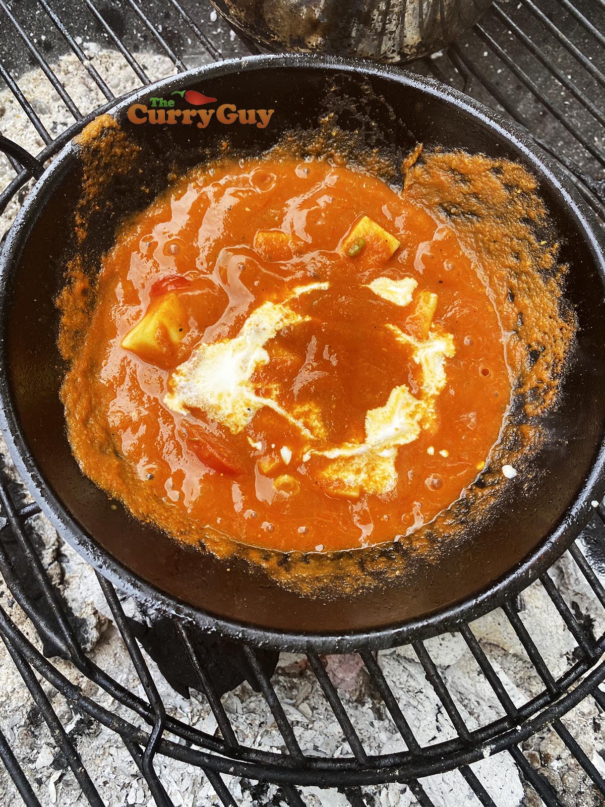 Adding cream to balti