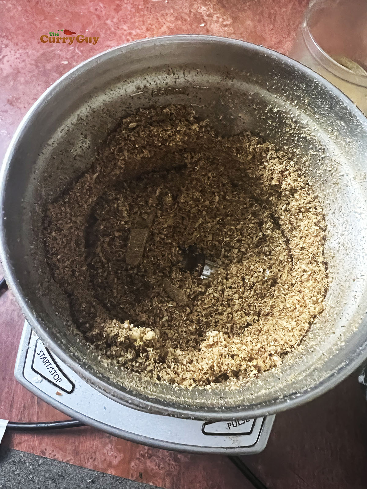Grinding the spices and coconut.