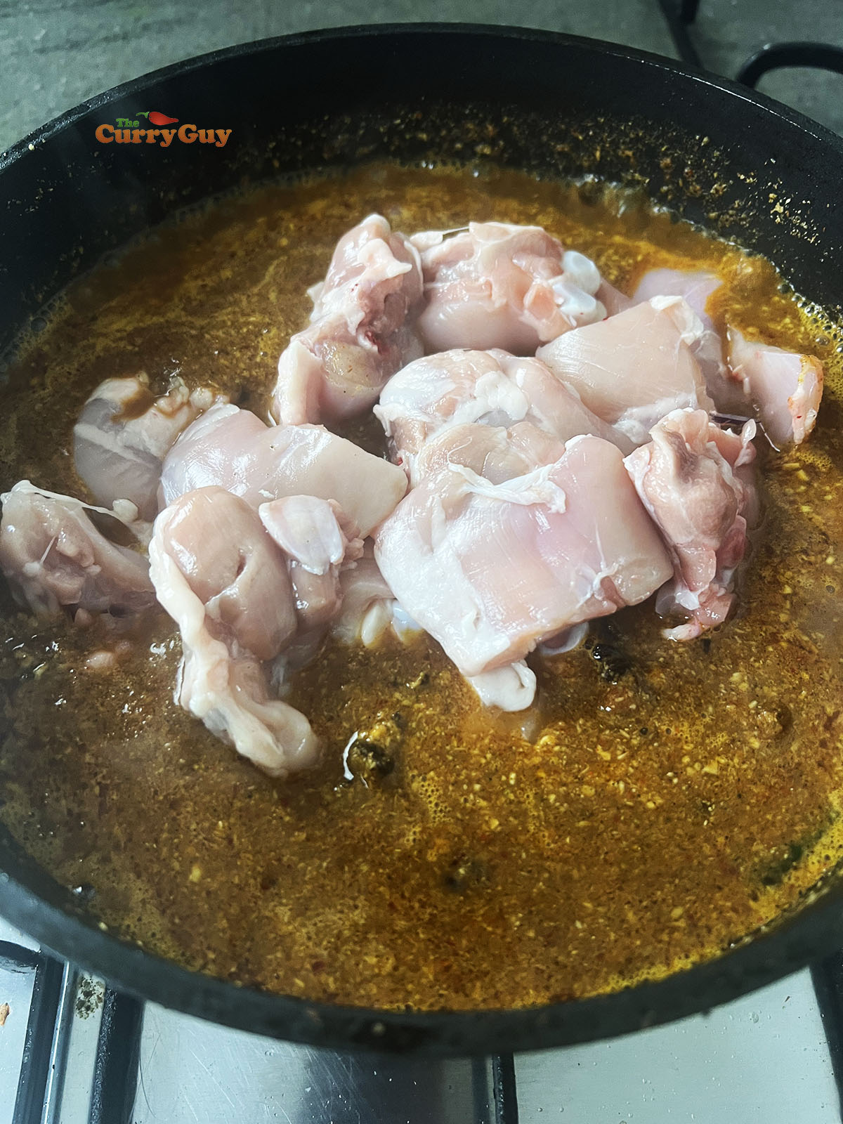 Adding the chicken to the sauce. 