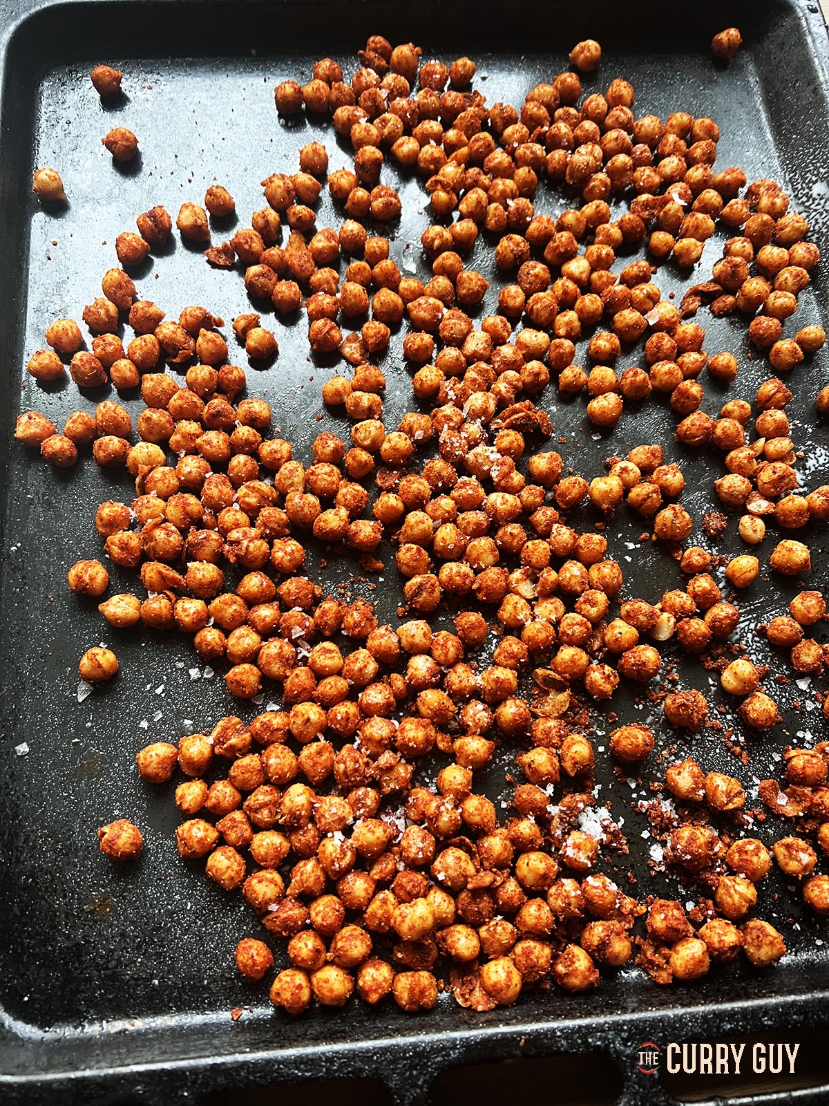 The spiced chickpeas on a roasting tray.
