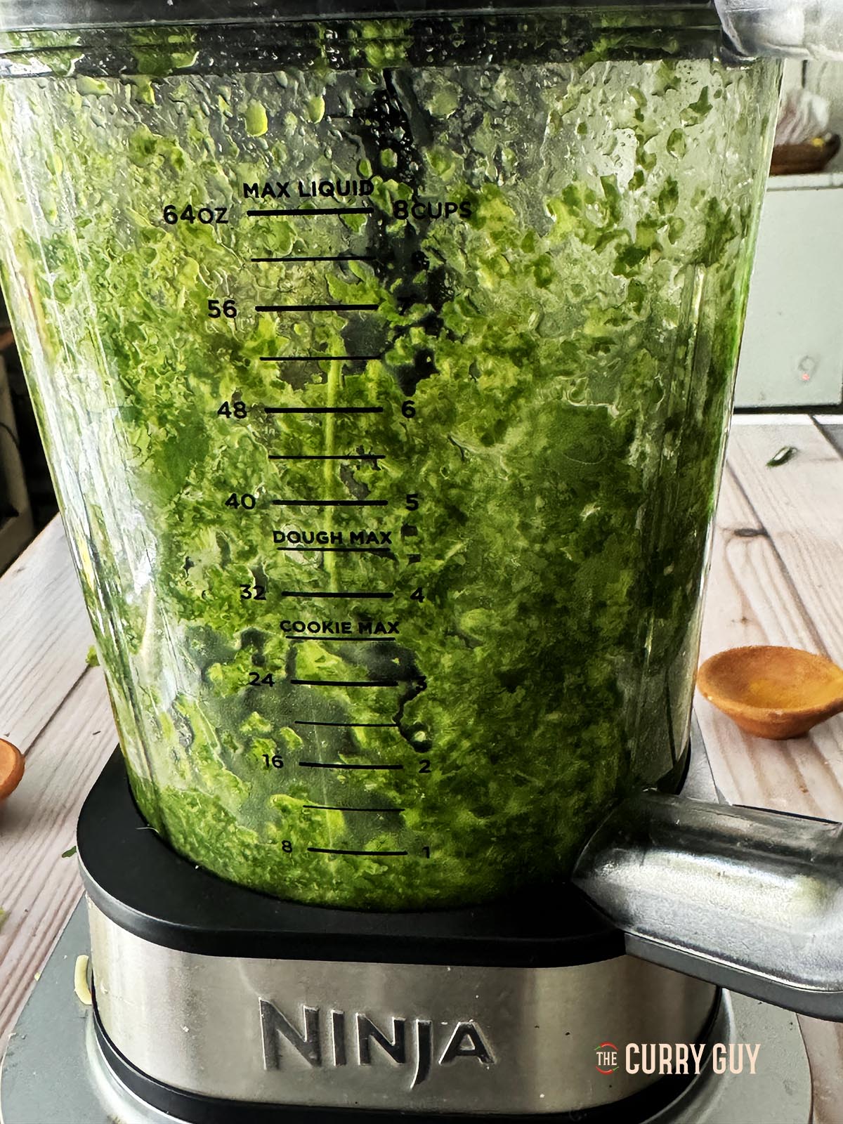 Blending the corander with lime juice to make a paste.