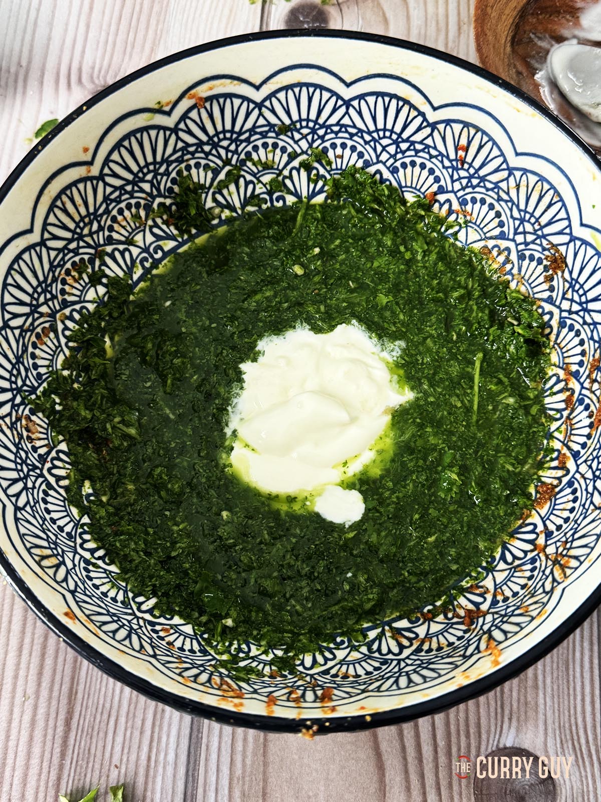 Stirring the yoghurt into the coriander paste.