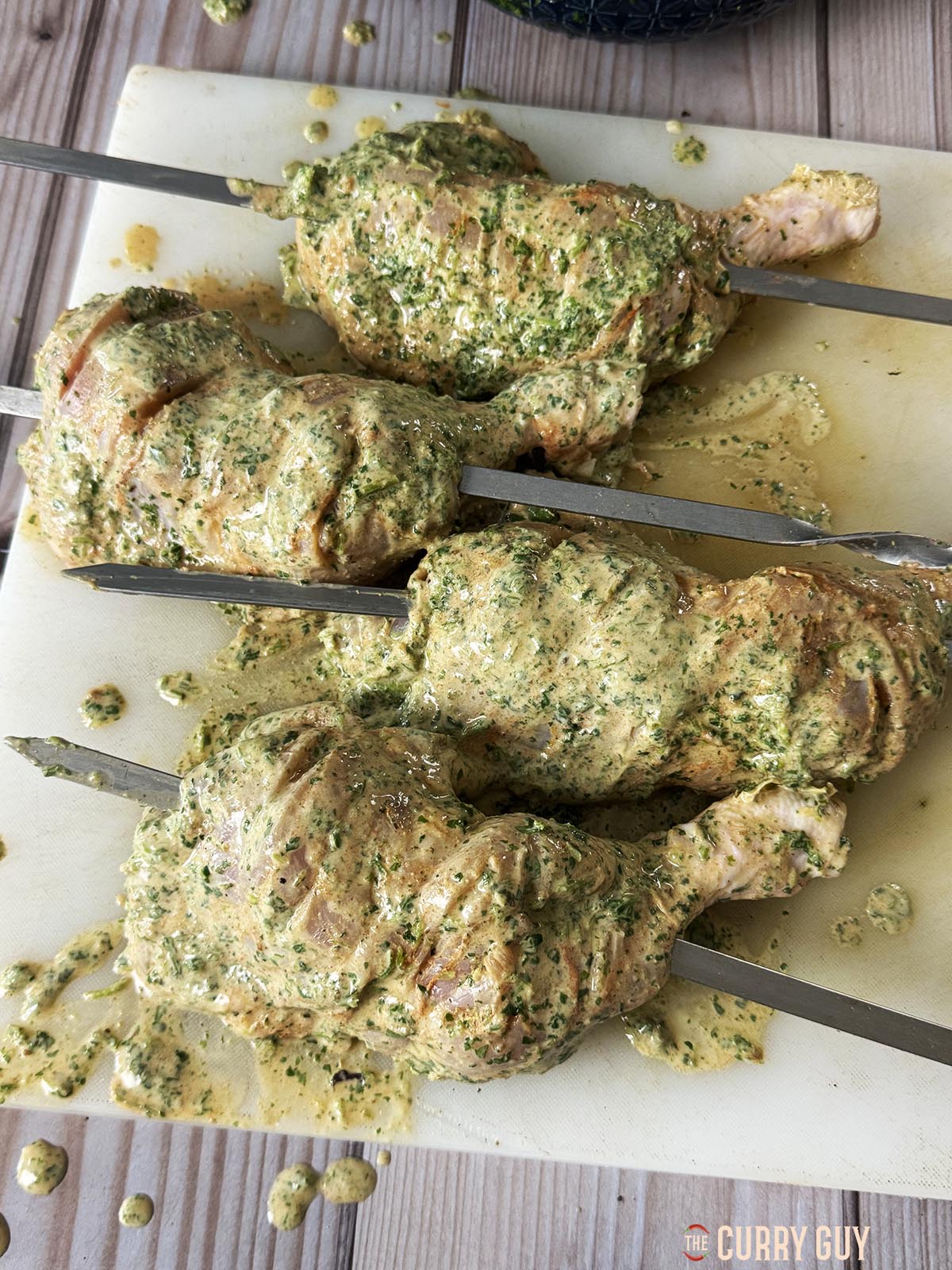 The marinated chicken legs on skewers.