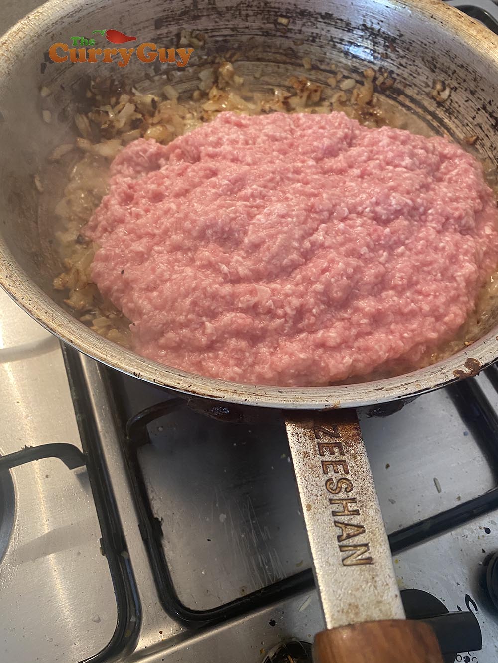 Stirring the meat into the lamb keema curry