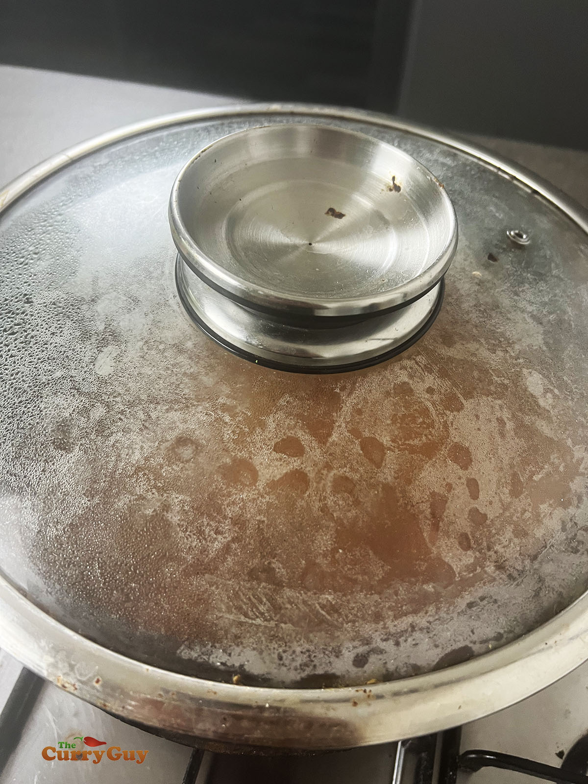 Simmering the lamb and sweet potatoes, covered in the pot.