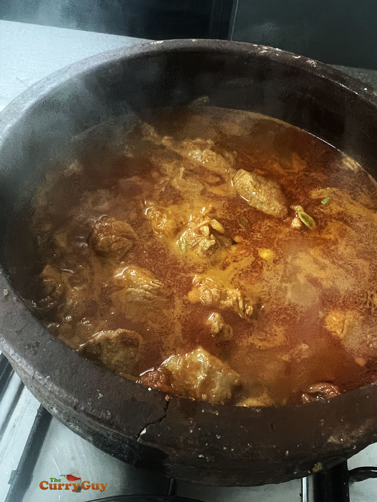Simmering the lamb in the broth.