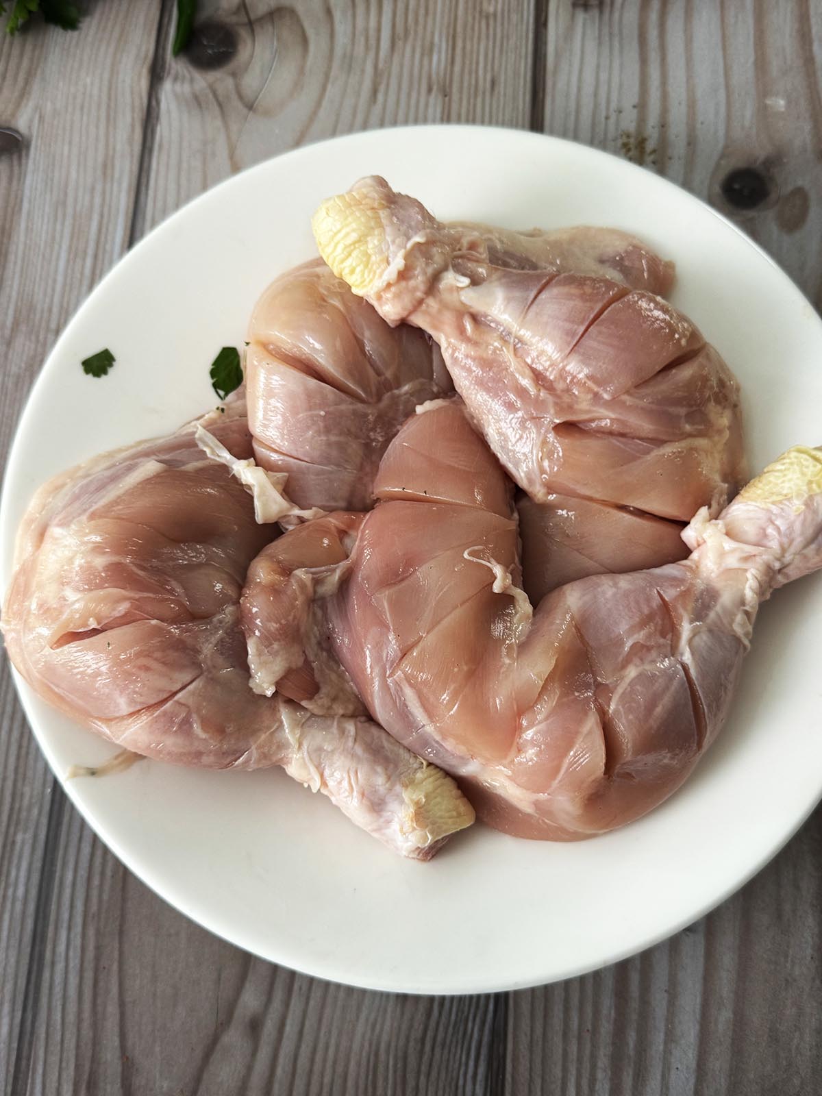 The chicken legs skinned and scored.