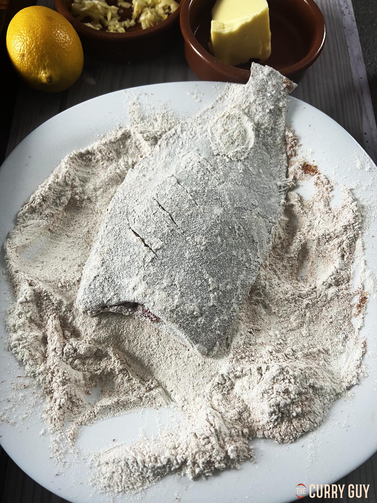 Dredging the fish in the flour and tandoori masala  mixture.