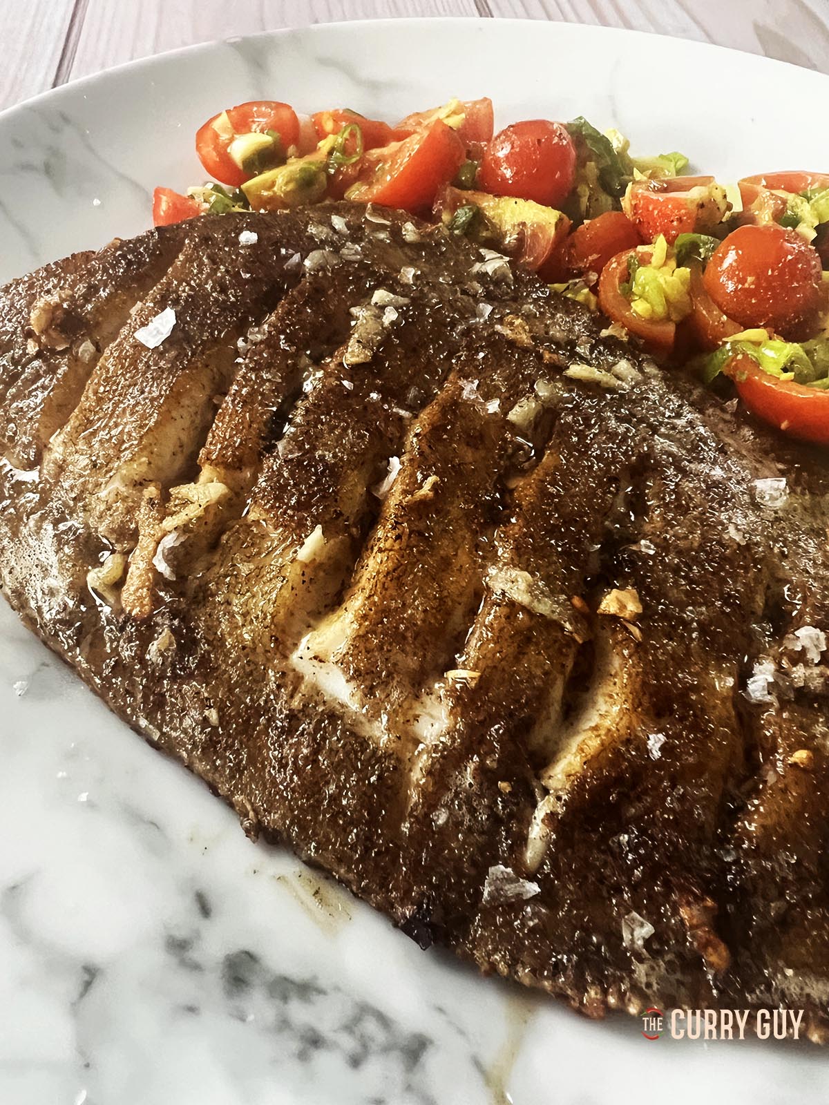 Pan fried lemon sole close up to show the crispiness of the skin.