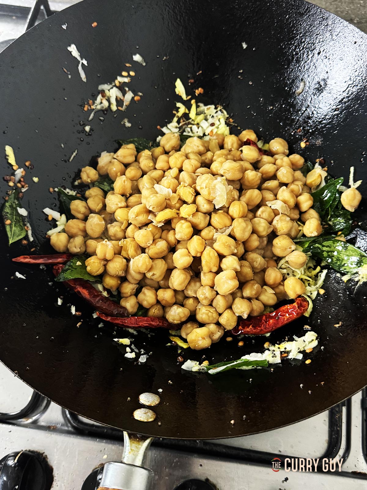 Adding the chickpeas to the pan.