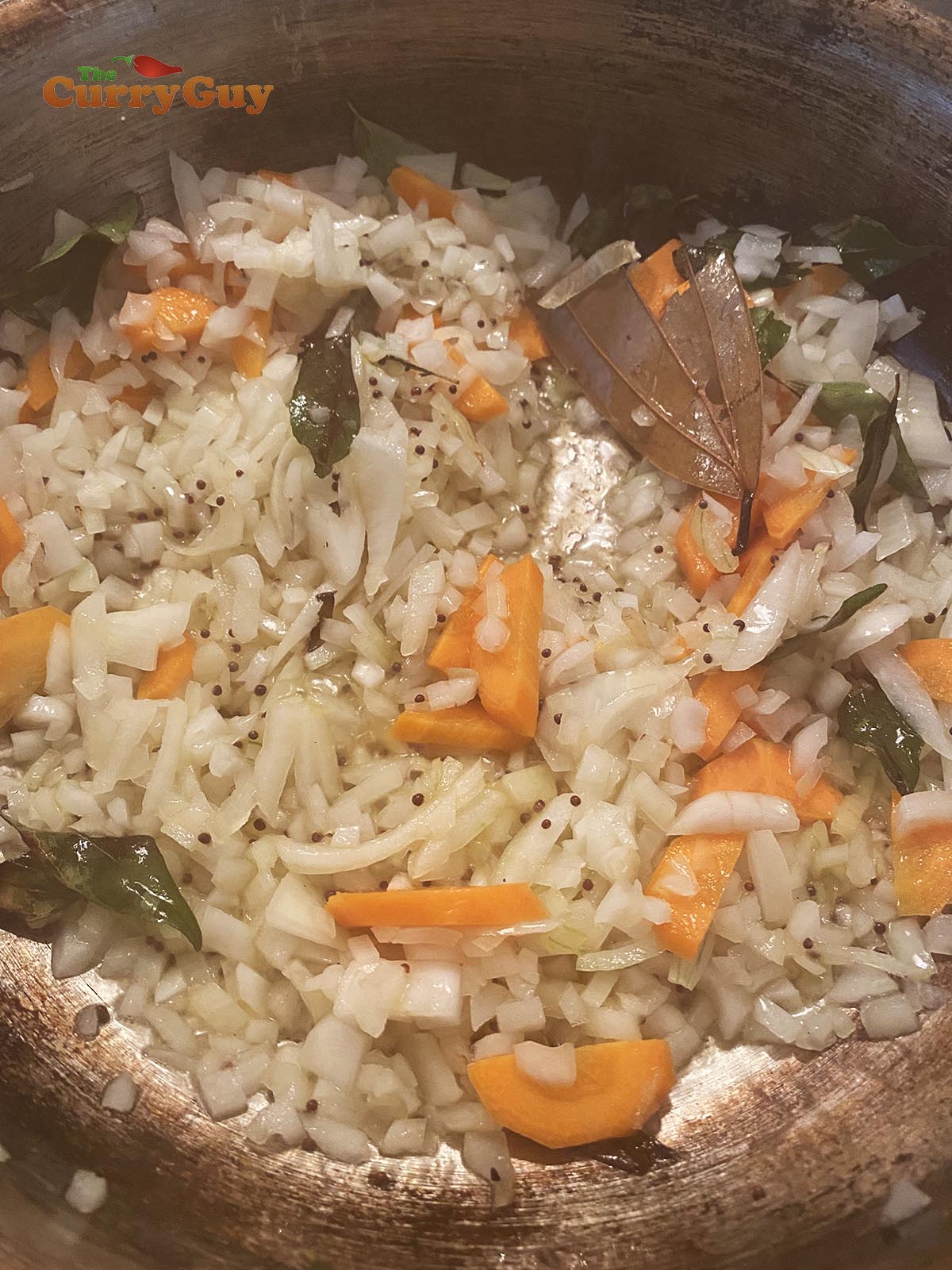 Adding onions to the pan.