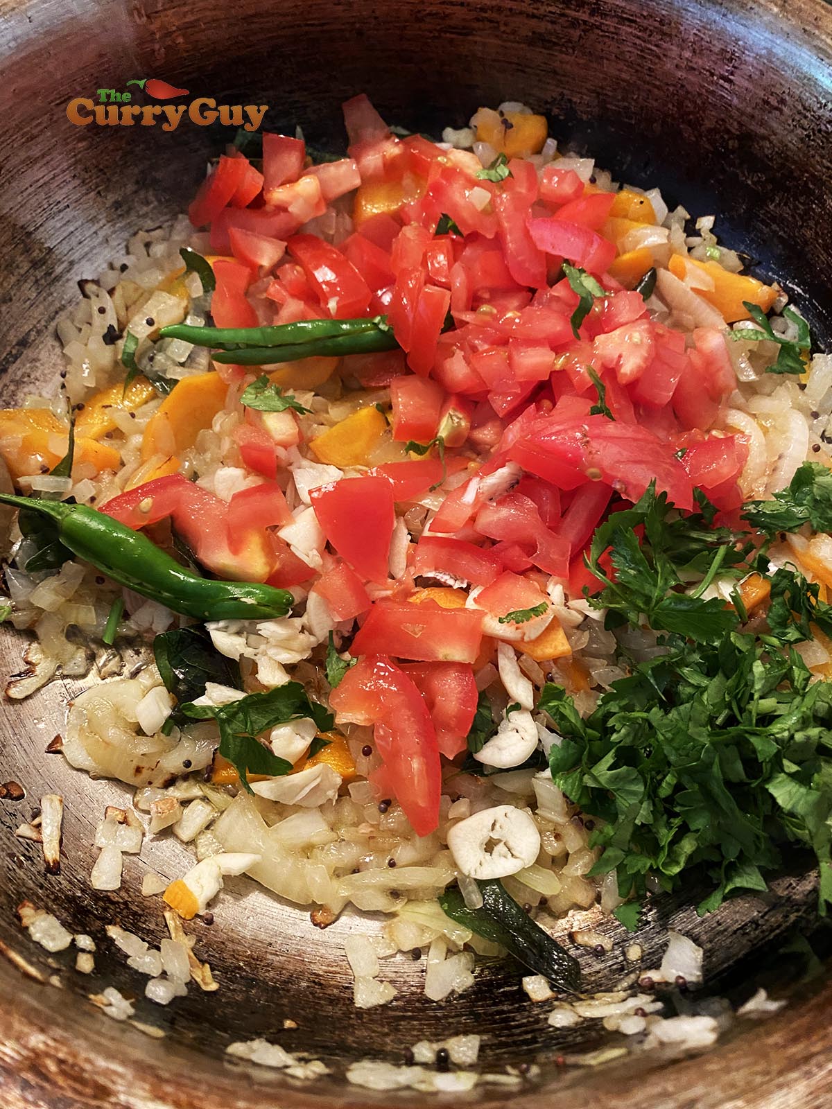 Adding tomatoes to pan