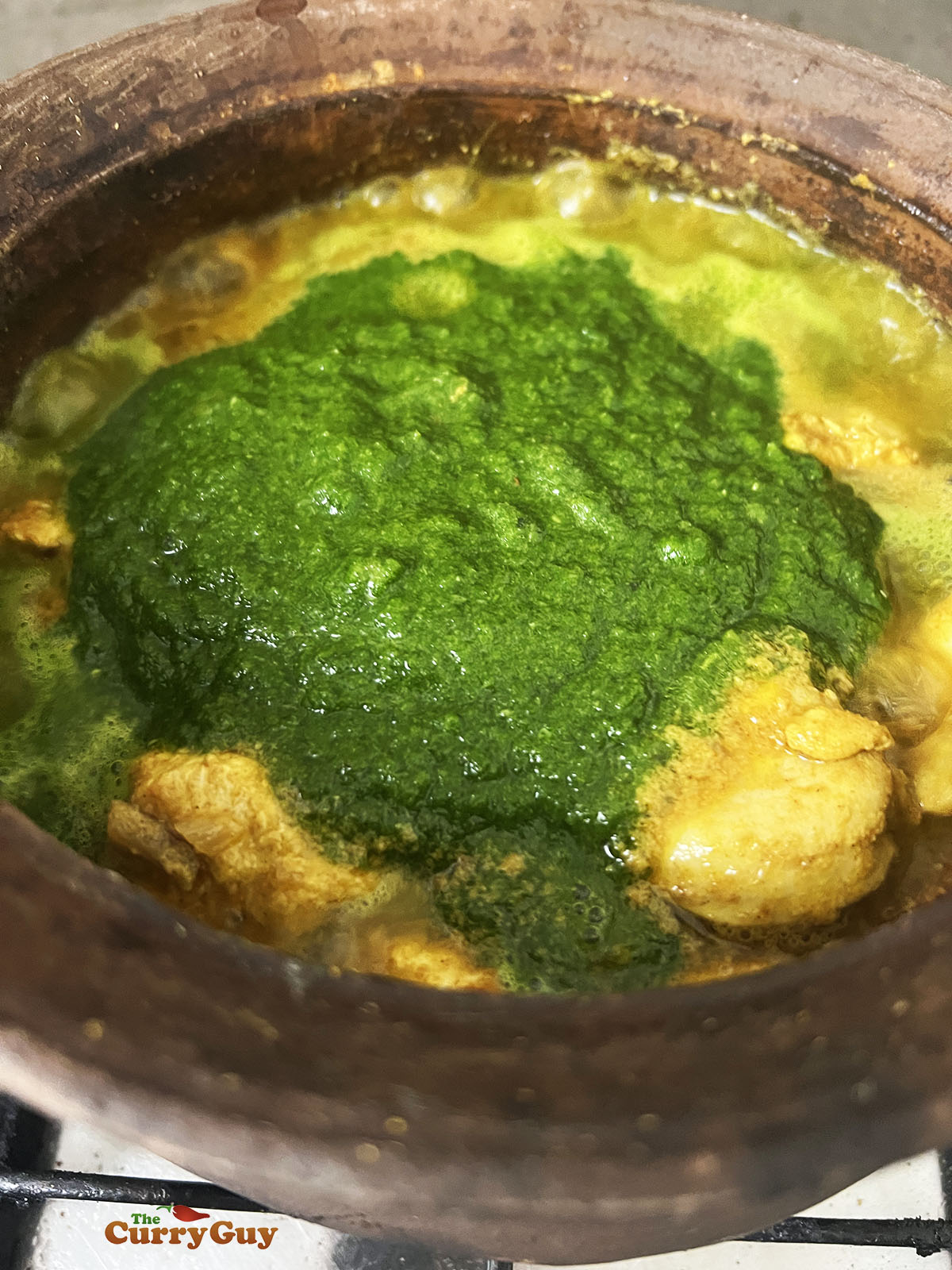 Adding the spice paste to the curry