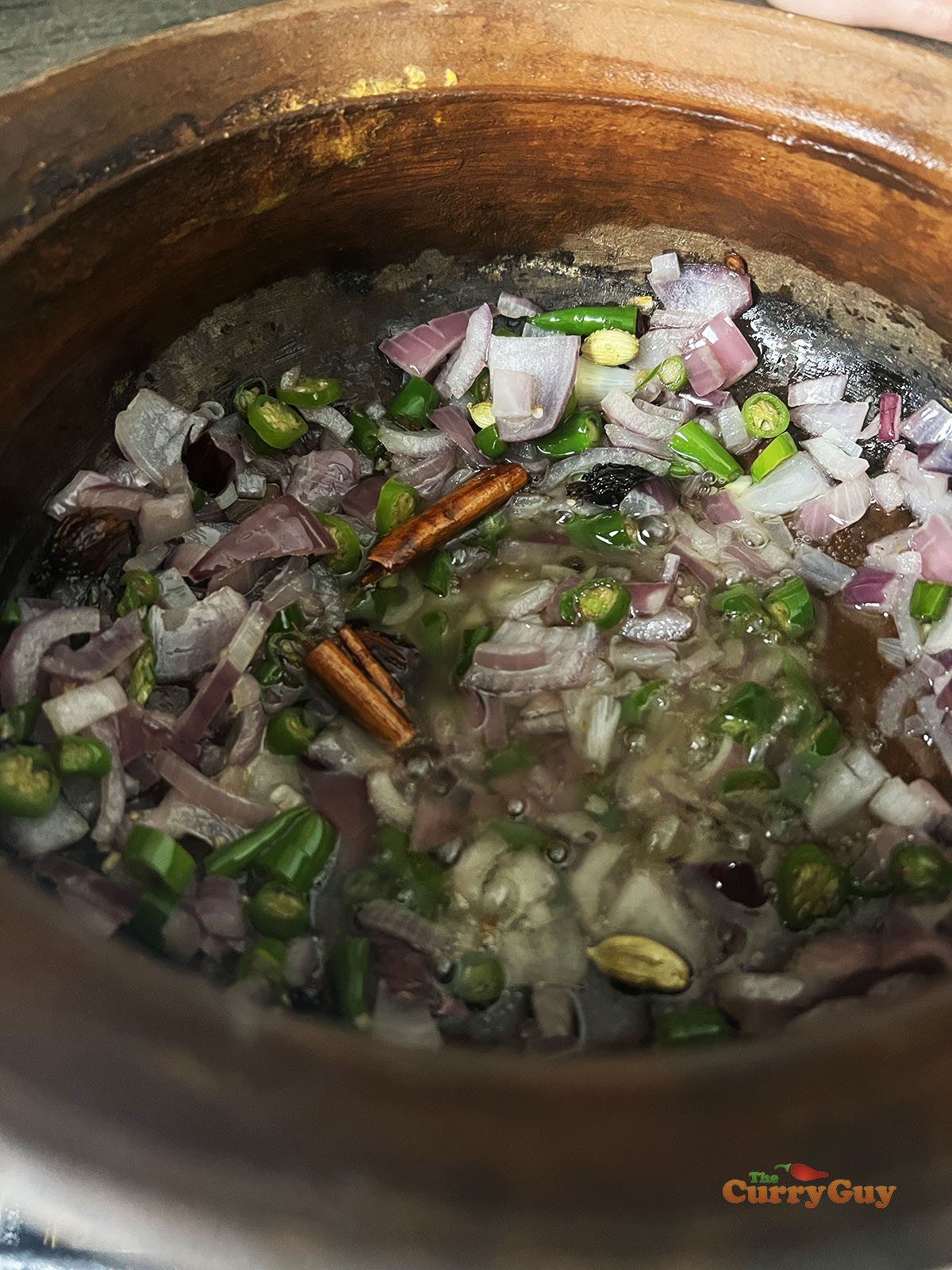Frying onions and chillies.