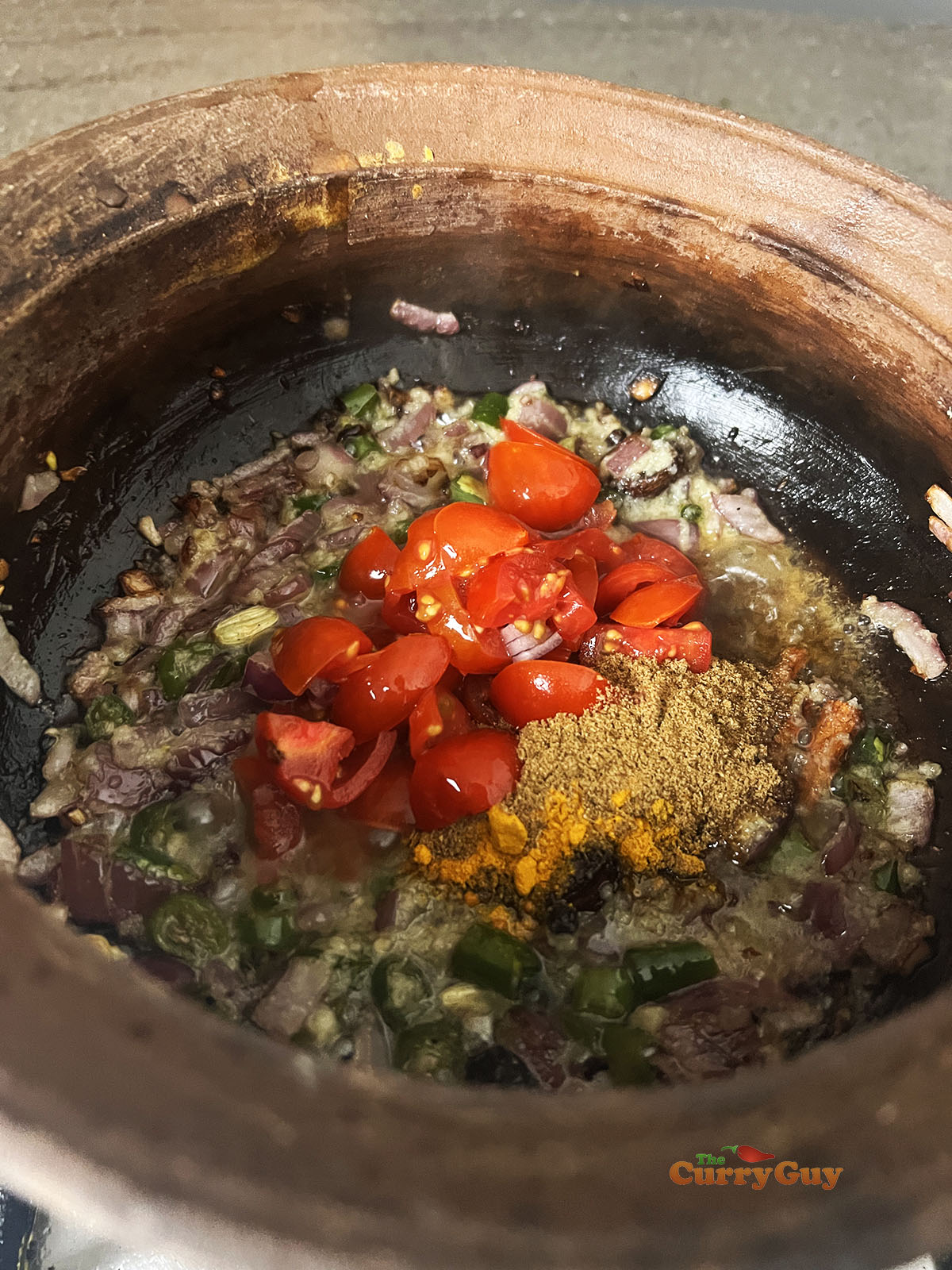 Frying tomatoes and ground spices.