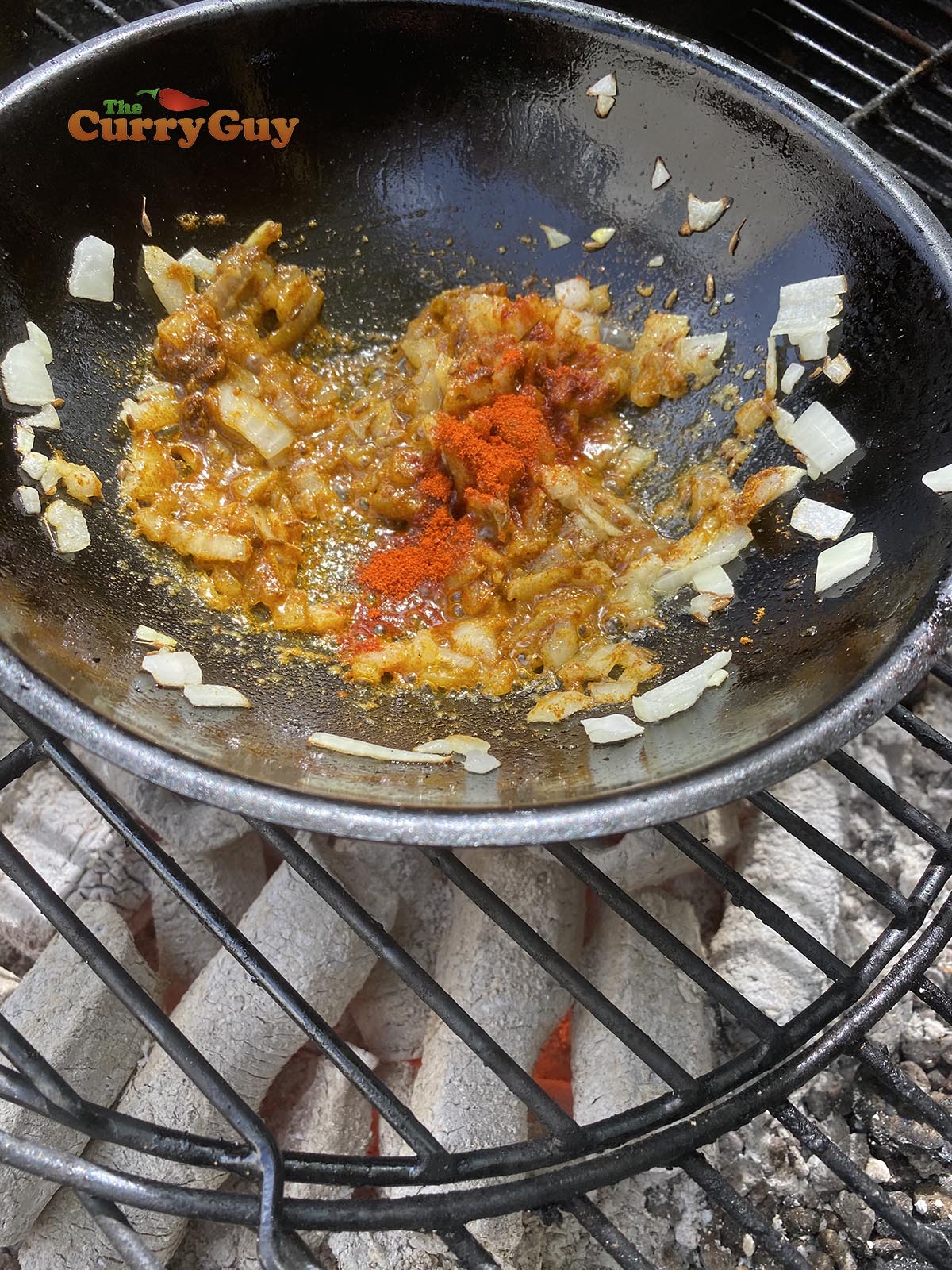 Adding ground spices to balti bowl