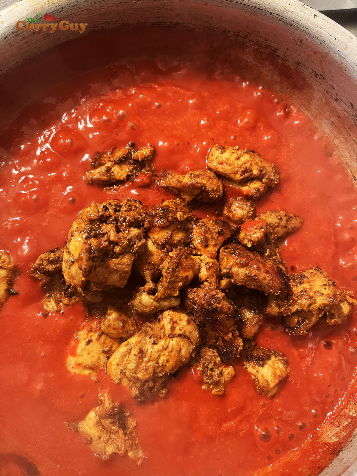 Adding chicken to the pan