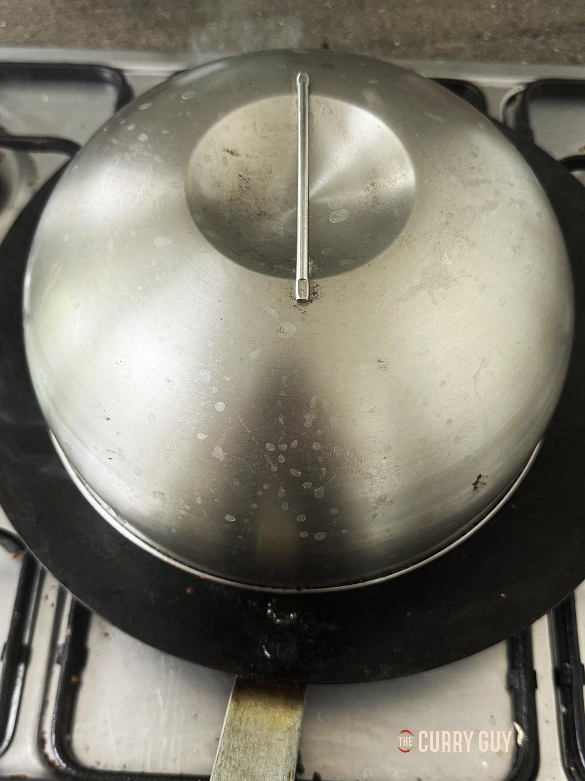 Covering the chicken mounds with a burger dome. You can do this with a pan lid too.