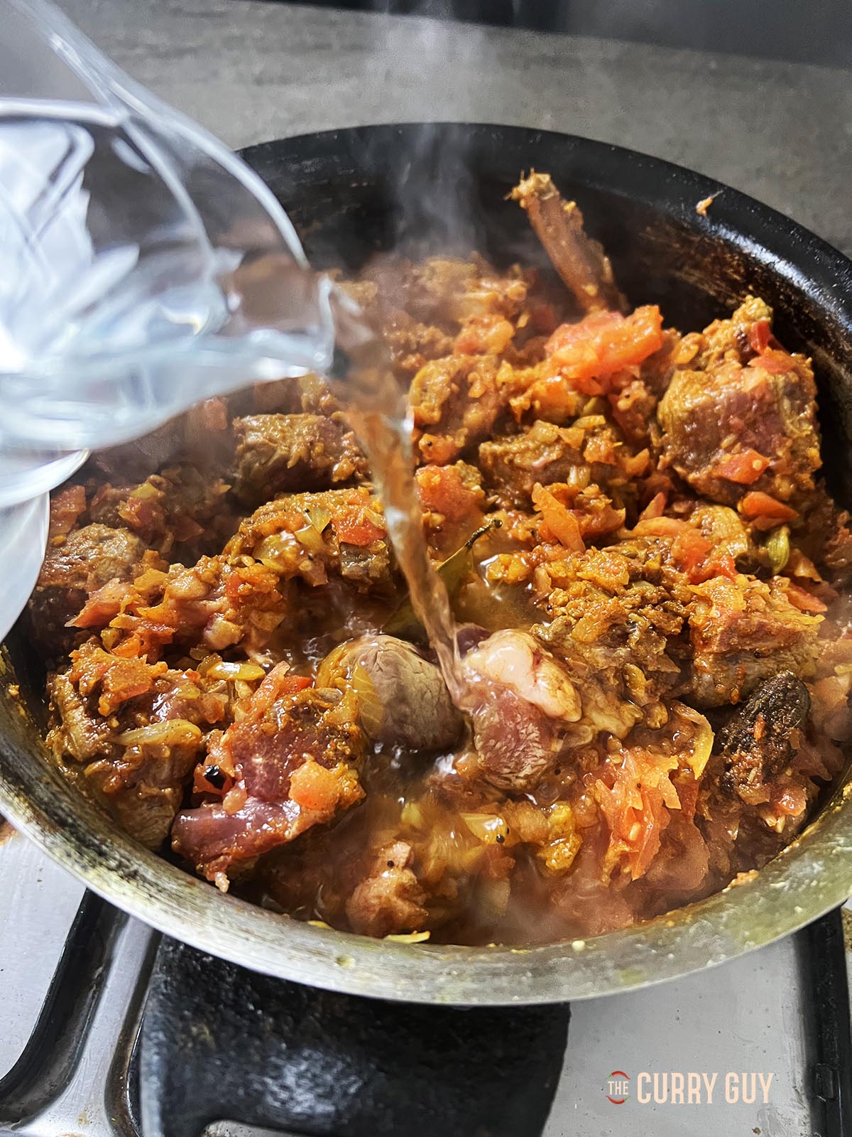 Adding water to the pan.