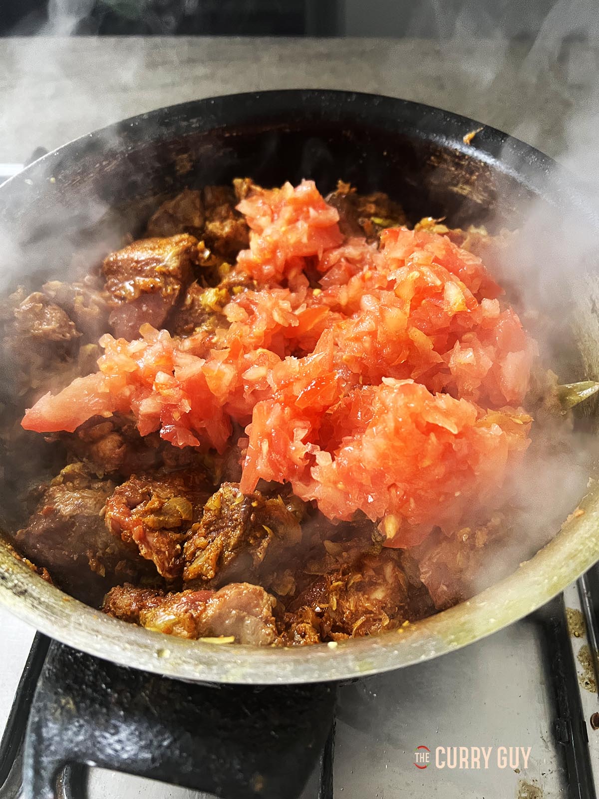 Adding the chopped tomatoes.