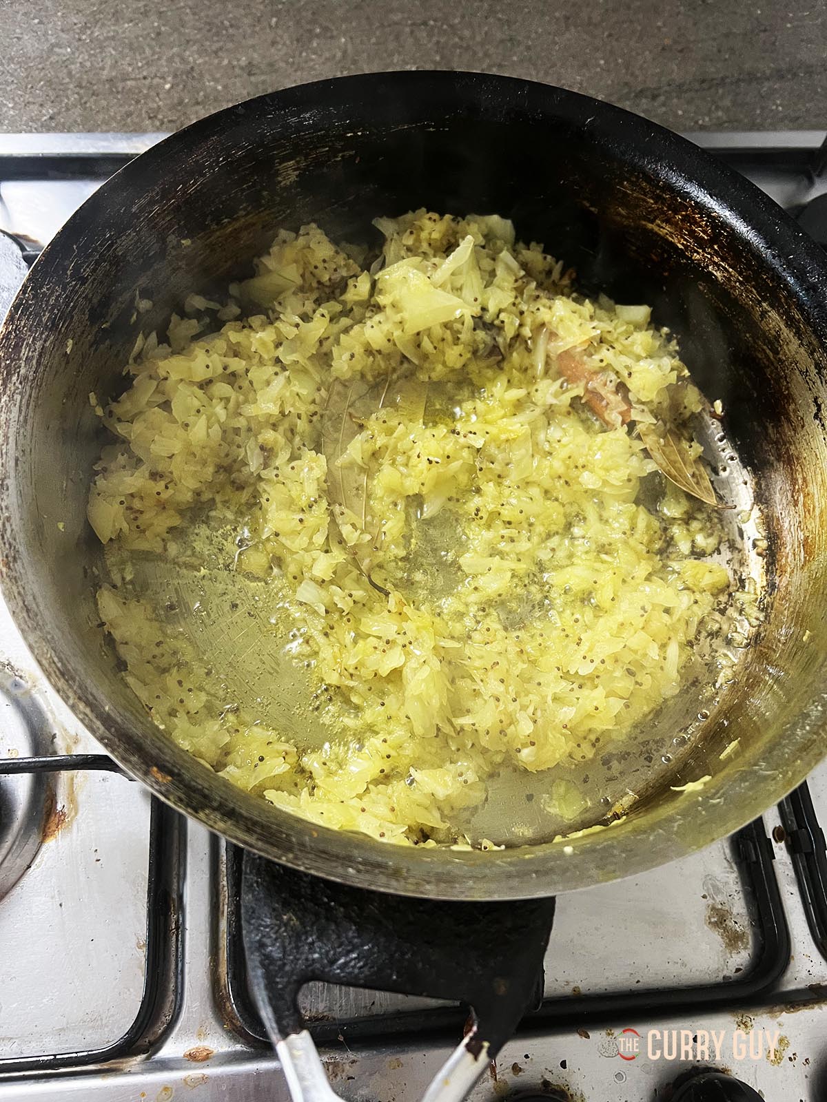 Frying the onions in the pan.