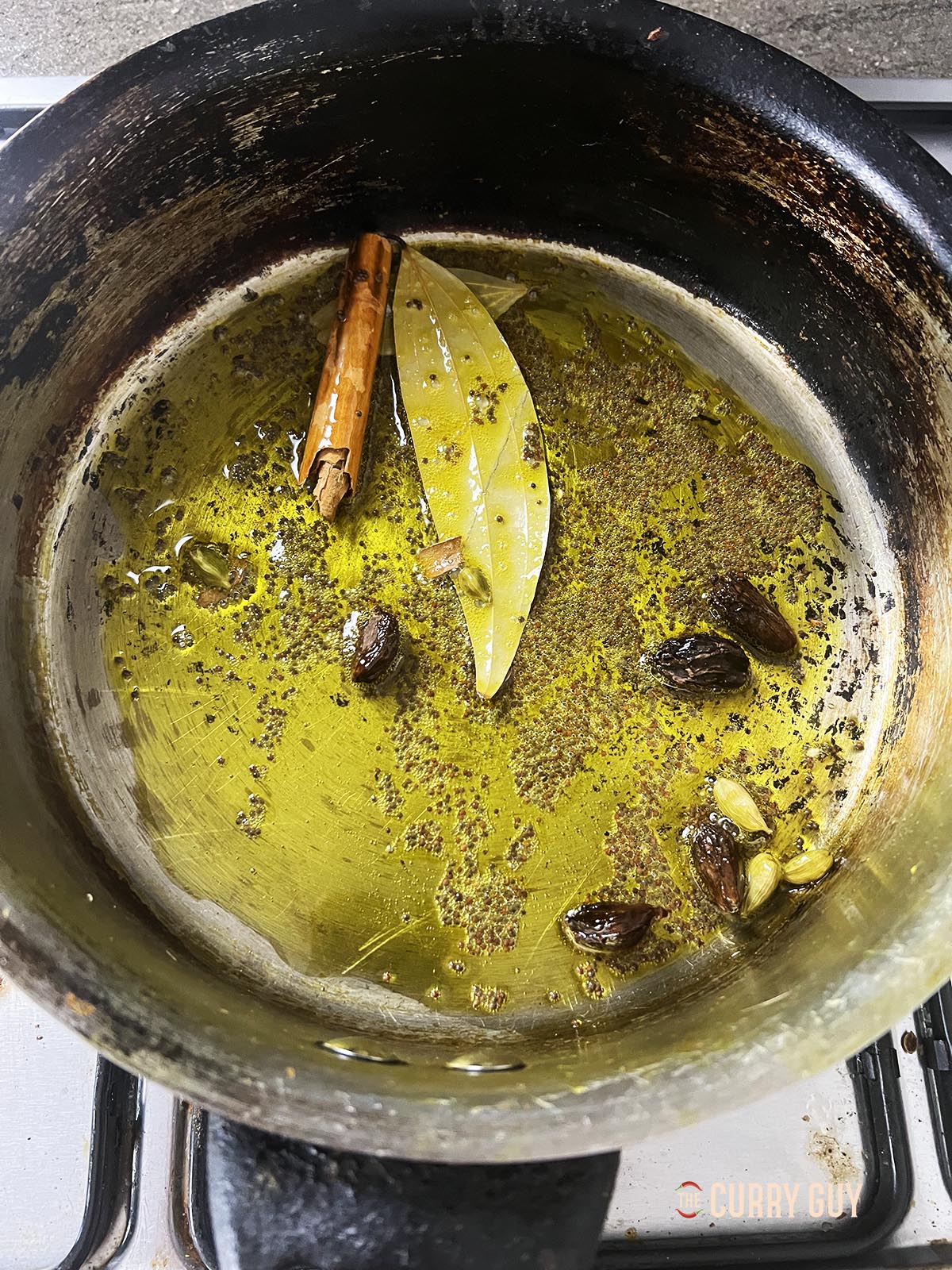 Adding the other whole spices to the hot oil. 