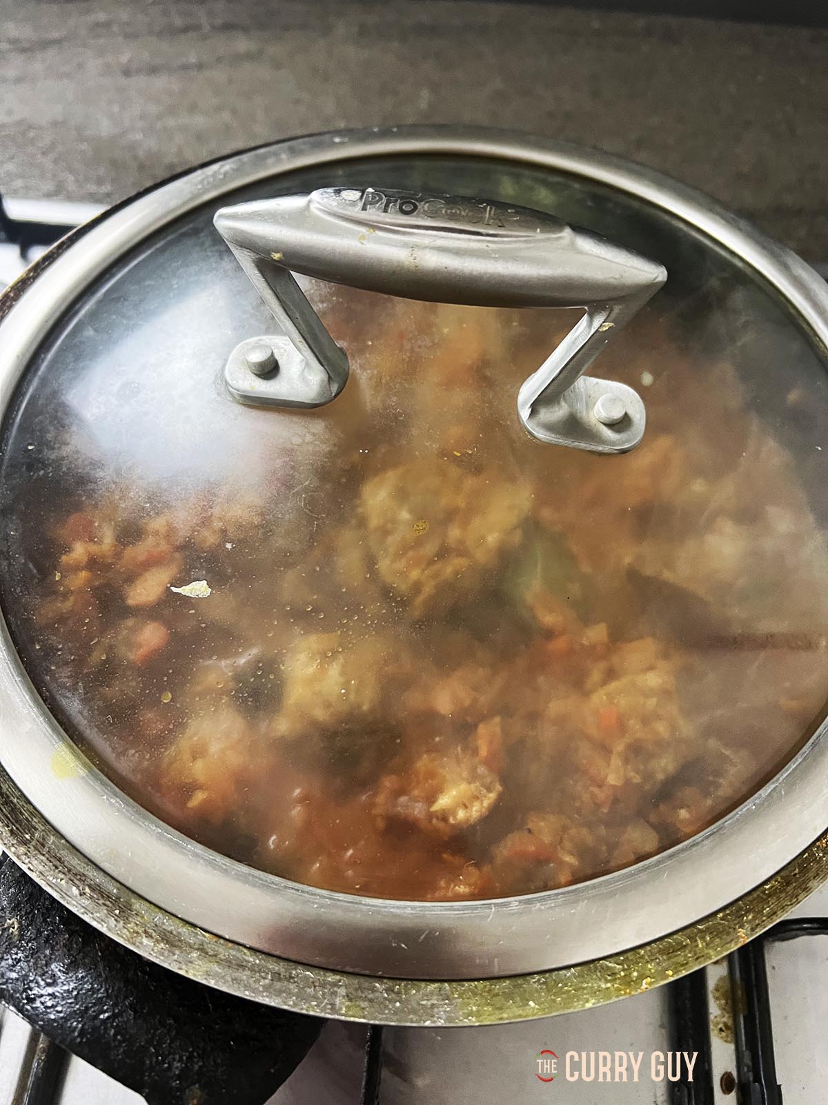 Covering the pan to simmer.