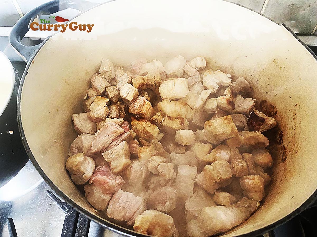 Frying the pork belly to brown it. 