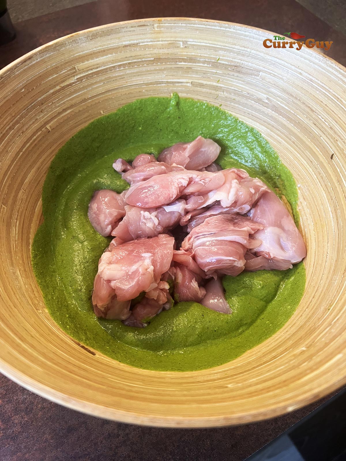 Adding chicken to marinade