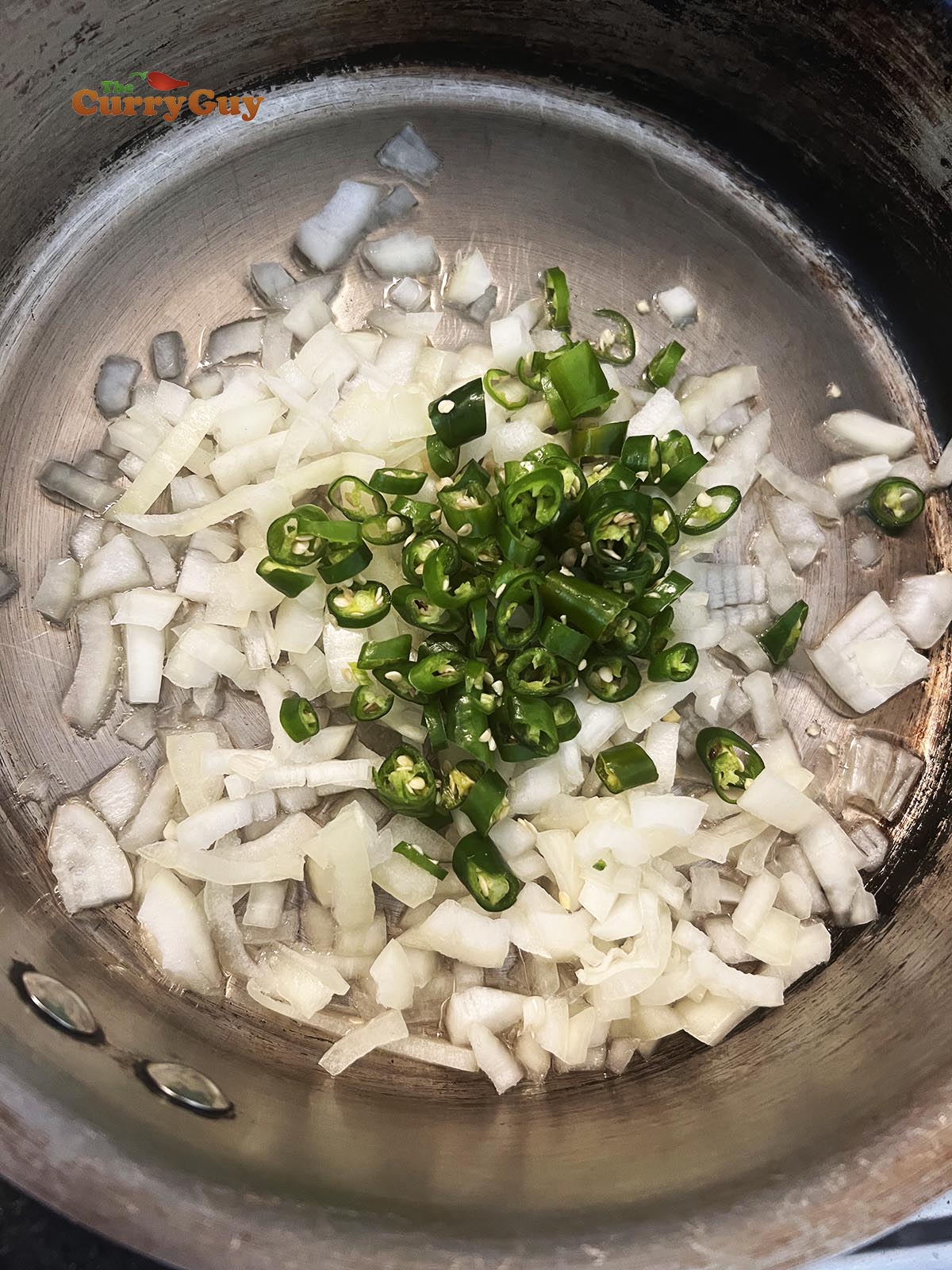 Frying onions and chillies in the pan.