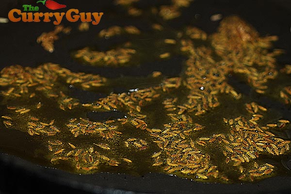 Cumin seeds sizzling in the hot mustard oil.