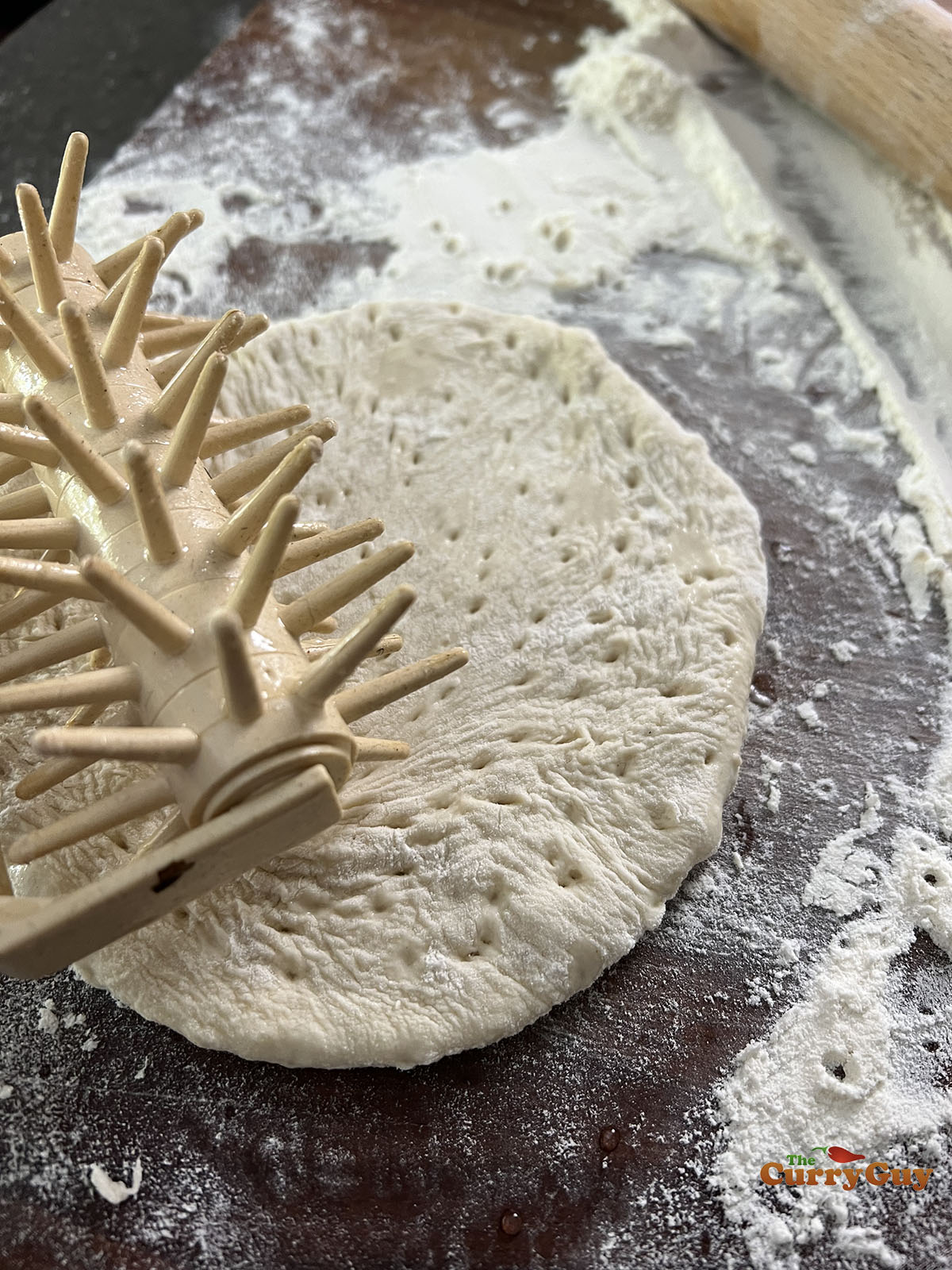 Making holes over the pita surface.