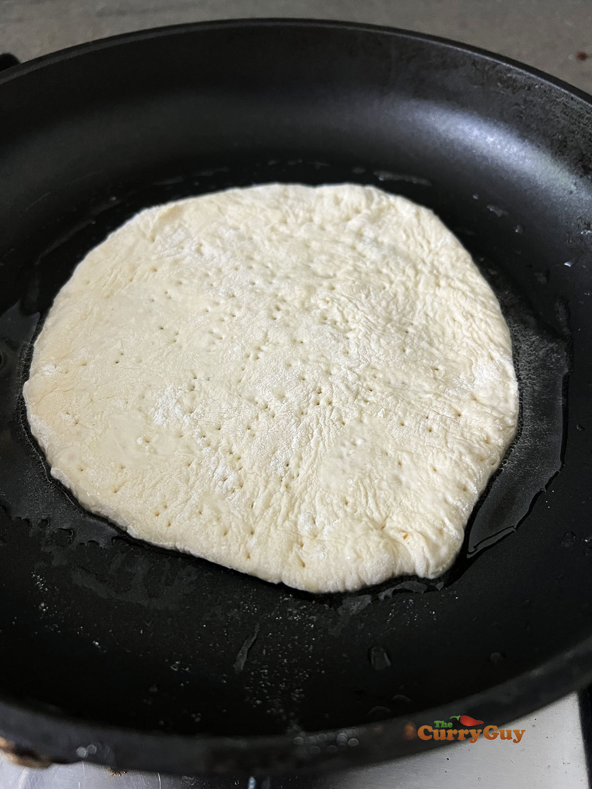 Frying the homemade pita.