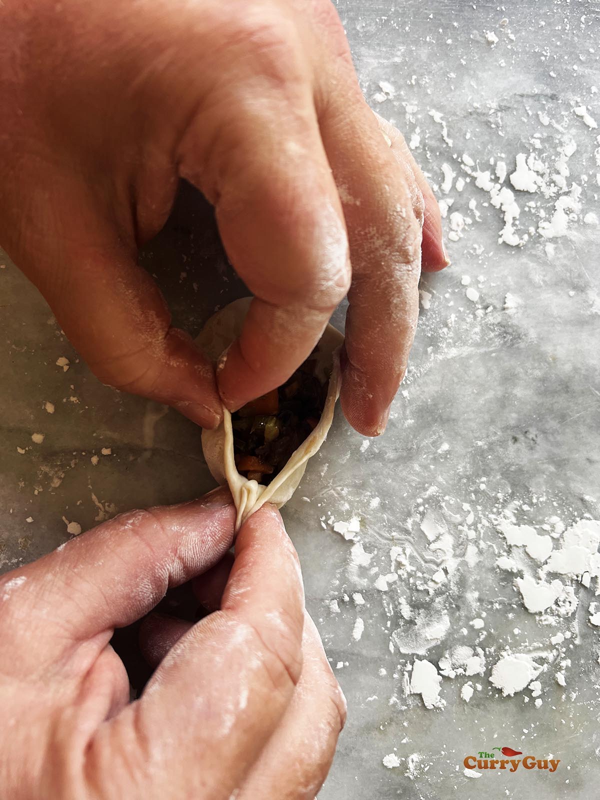 Making pleats in the wrapper to seal it.