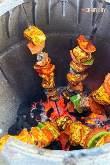 Paneer tikka and vegetables, skewered in a tandoor oven.