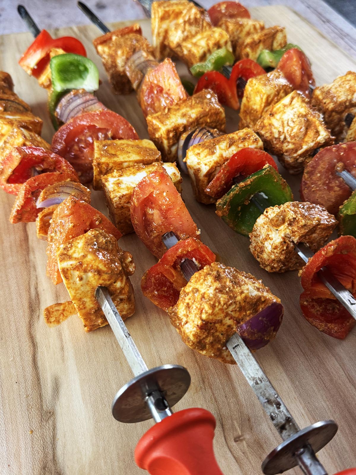 Paneer and vegetables skewered and ready to place in the tandoor oven.