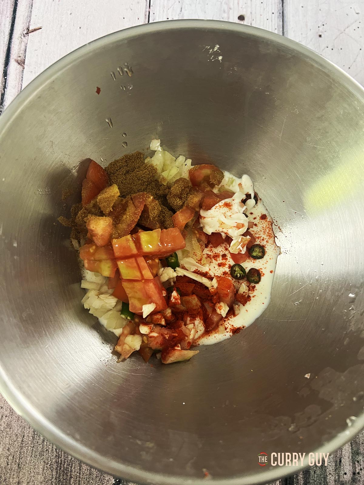 All of the finely chopped ingredients in a mixing bowl