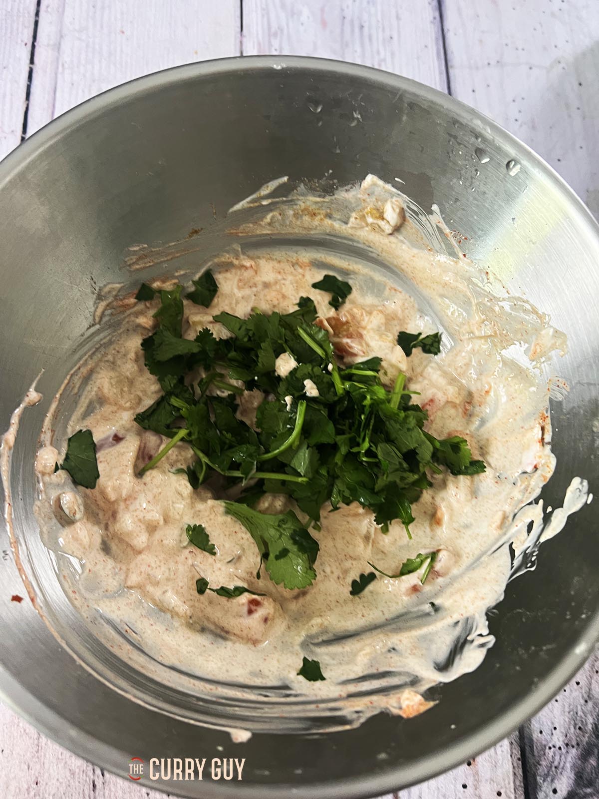 Whisking the ingredients together in the bowl.