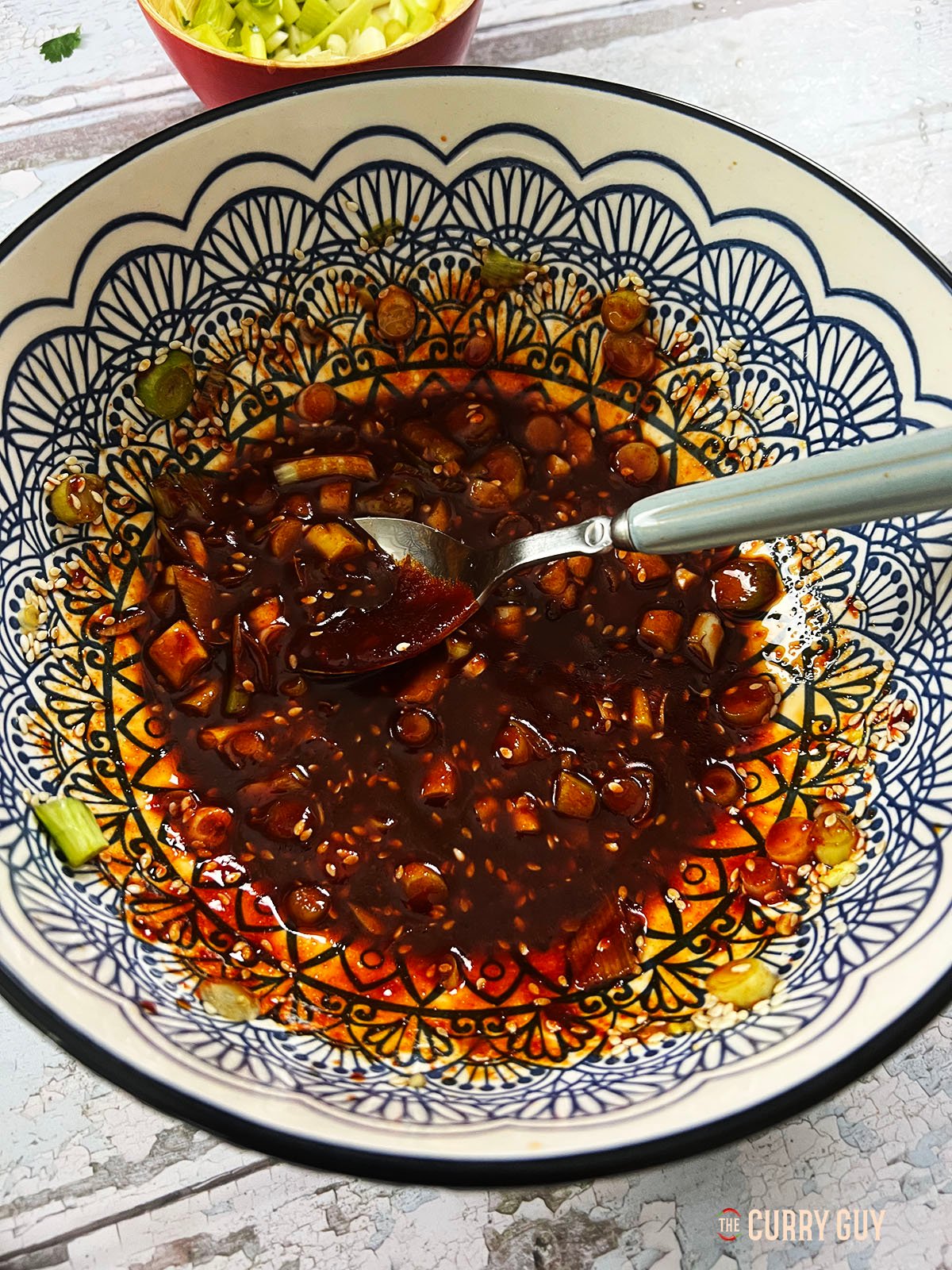 The dressing whisked together in a bowl. 