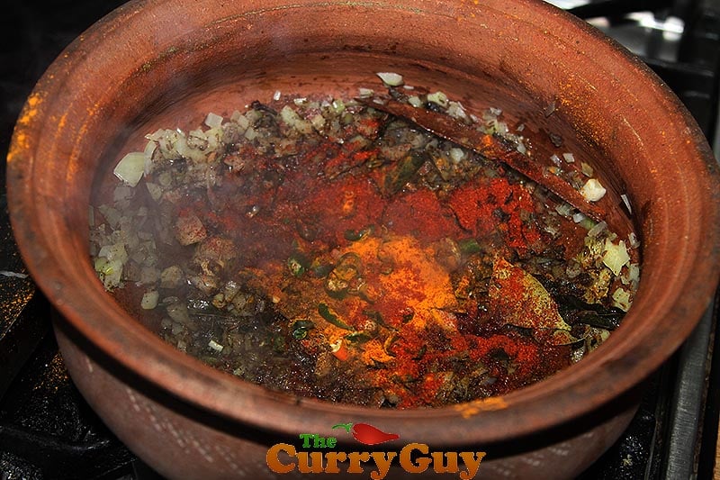Making black chicken curry