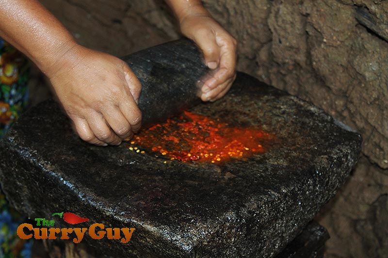 Making coconut, chilli and onion chutney