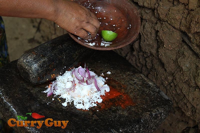 Making coconut, chilli and onion chutney