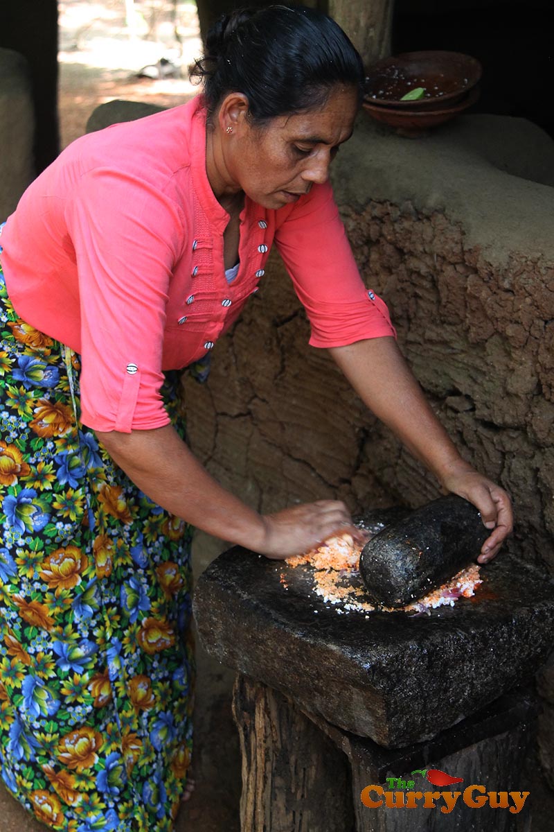 Making coconut, chilli and onion chutney